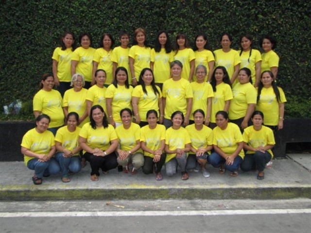 The Hands of Mercy Team pictured on steps in the Philippines. They are all wearing a Hands of Mercy T-shirt.